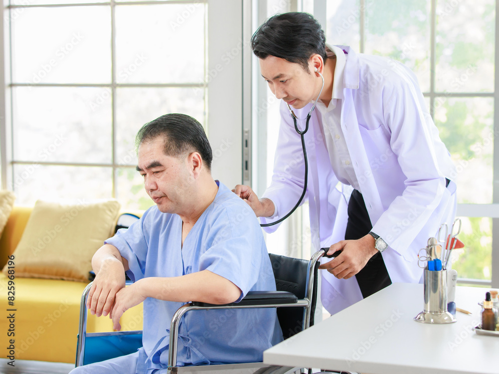 Fototapeta premium Asian smart man doctor is using a stethoscope listen to the heartbeat of elderly patient. Shot of a male doctor giving a male patient check up in hospital, Healthcare concept.