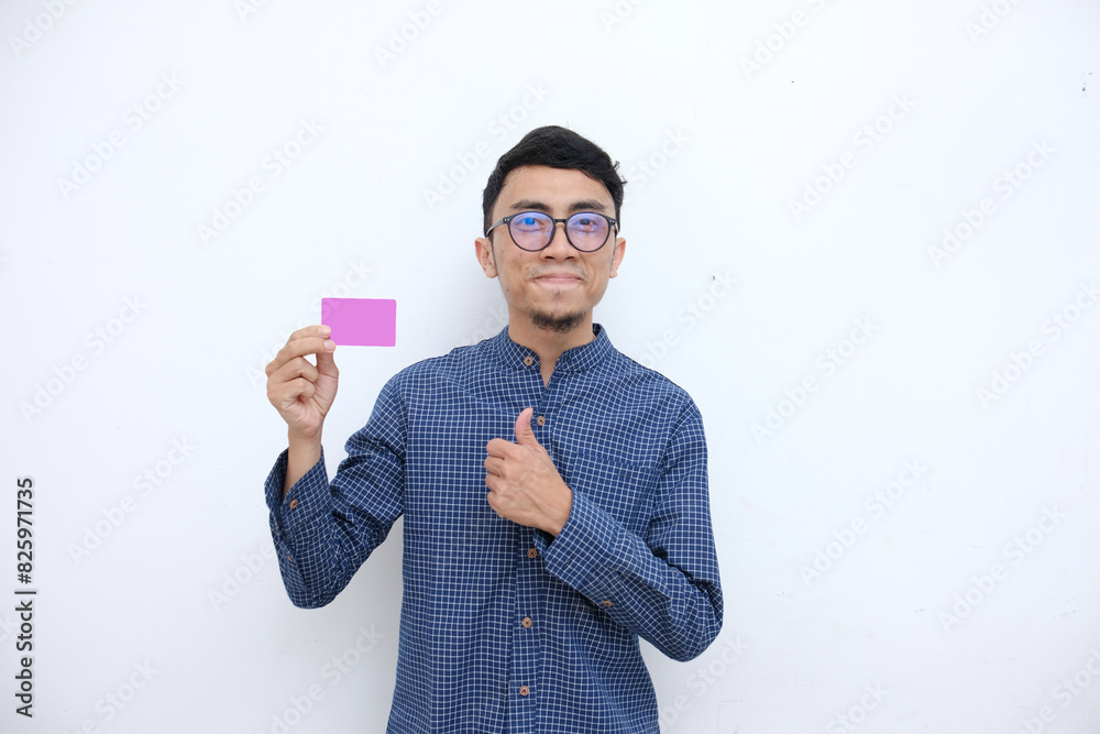 smiling expression with showing card, asian face in blue shirt dress and white isolated background. smiling expression with showing card, asian face in blue shirt dress and white isolated background.