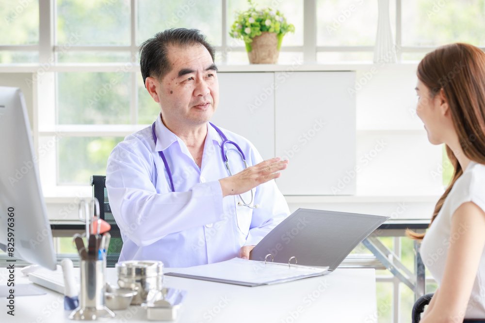Asian senior man doctor in hospital or clinic talking to nervous young female patient trying to calm down worried woman and asking her to relax. Medicine, healthcare and people concept Asian senior man doctor in hospital or clinic talking to nervous young female patient trying to calm down worried woman and asking her to relax. Medicine, healthcare and people concept