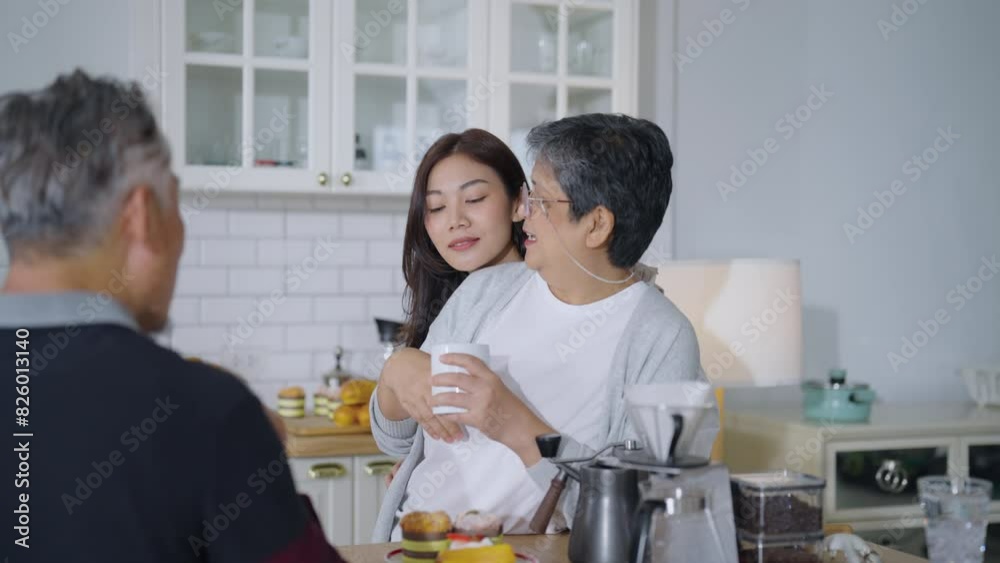 Asian family, consisting of a mother, father, and daughter, talking together in morning and prepare breakfast for parent moment of bonding in the kitchen area of their home. Asian family, consisting of a mother, father, and daughter, talking together in morning and prepare breakfast for parent moment of bonding in the kitchen area of their home.