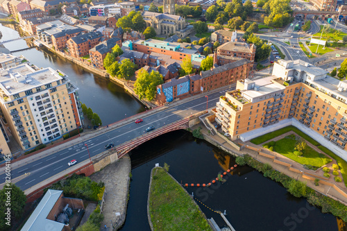 Aerial footage of the Leeds city centre in West Yorkshire in the UK showing the main bridge going in to the city centre over the famous canal in the British city