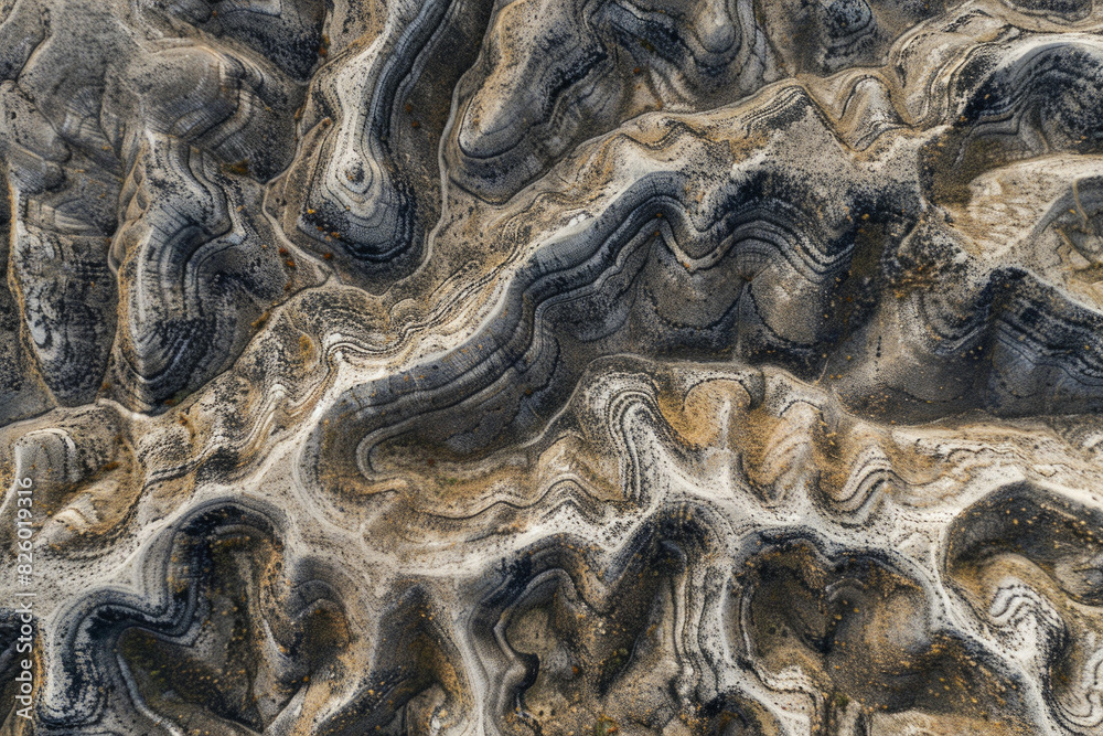 Minimalist aerial view of mountain ridges, showcasing sharp lines and natural patterns in the terrain. 