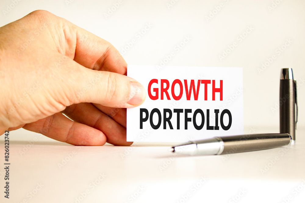 Growth portfolio symbol. Concept words Growth portfolio on beautiful white paper. Beautiful white background. Businessman hand. Business Growth portfolio concept. Copy space. Growth portfolio symbol. Concept words Growth portfolio on beautiful white paper. Beautiful white background. Businessman hand. Business Growth portfolio concept. Copy space.