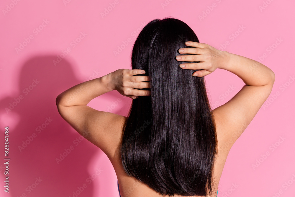 Photo of charming woman nude shoulders enjoying haircare empty space isolated pink color background