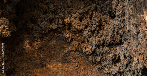 Black soot background in bright light. The inside of a clogged chimney pipe. Macro shot. Texture of combustion products.