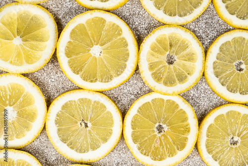 Bright citrus background of sliced fresh lemons top view.