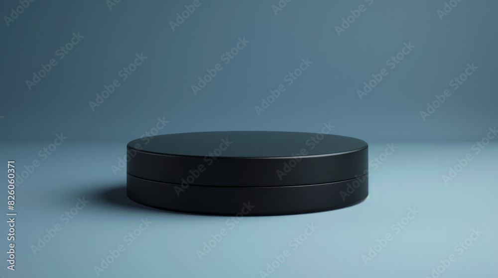 A black object with a circular shape is on a blue background A black object with a circular shape is on a blue background