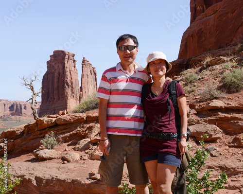 Happy couple posing for photos at Arches National Park. Utah. USA.