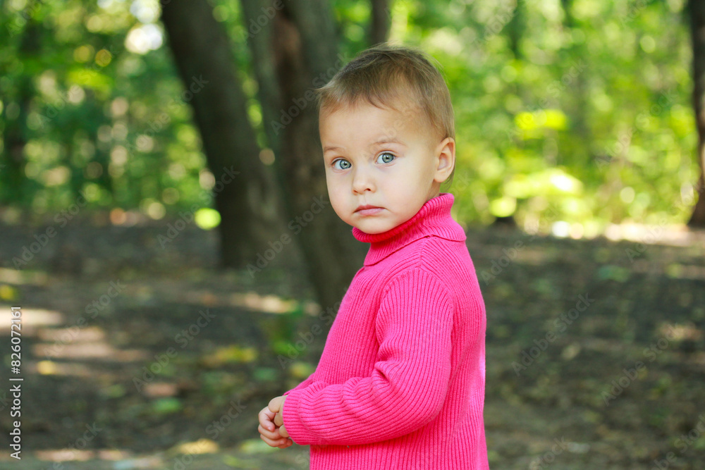 Little adorable serious girl in spring outdoors. Little adorable serious girl in spring outdoors.