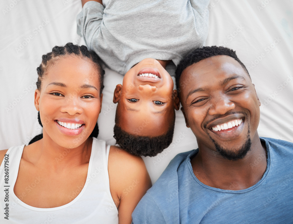 Top view, bed and portrait of parents with love, happiness and bonding or having fun on weekend. People, black family and mother with father and child laying in bedroom to relaxing in morning Top view, bed and portrait of parents with love, happiness and bonding or having fun on weekend. People, black family and mother with father and child laying in bedroom to relaxing in morning