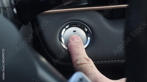 Male hand presses car engine start button. Engine stop start button.