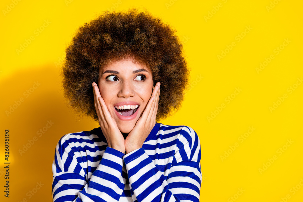 Photo of nice young girl look empty space ad wear striped shirt isolated on yellow color background Photo of nice young girl look empty space ad wear striped shirt isolated on yellow color background