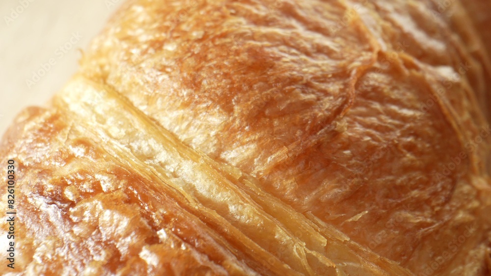 Croissant: Popular French pastry, flaky, buttery, crescent-shaped. Layered dough rolled or folded for delicate, airy interior and crisp, golden-brown layers outside. Fast-food background. 
