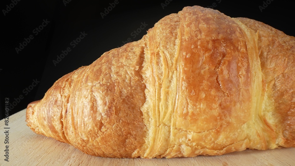 A croissant is a buttery, flaky, crescent-shaped pastry that originated in France. It is made from layered yeast-leavened dough, which is folded and rolled several times in succession. Food concept.
A croissant is a buttery, flaky, crescent-shaped pastry that originated in France. It is made from layered yeast-leavened dough, which is folded and rolled several times in succession. Food concept.