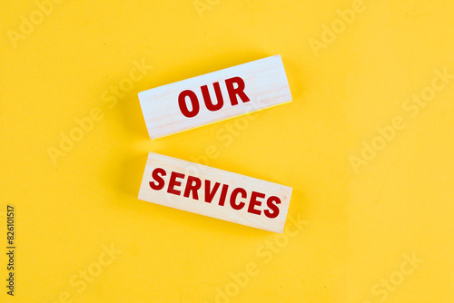 Writing text showing Our Service. Business photo with words OUR SERVICES a conceptual phrase on wooden blocks lying on a beautiful uniform tone