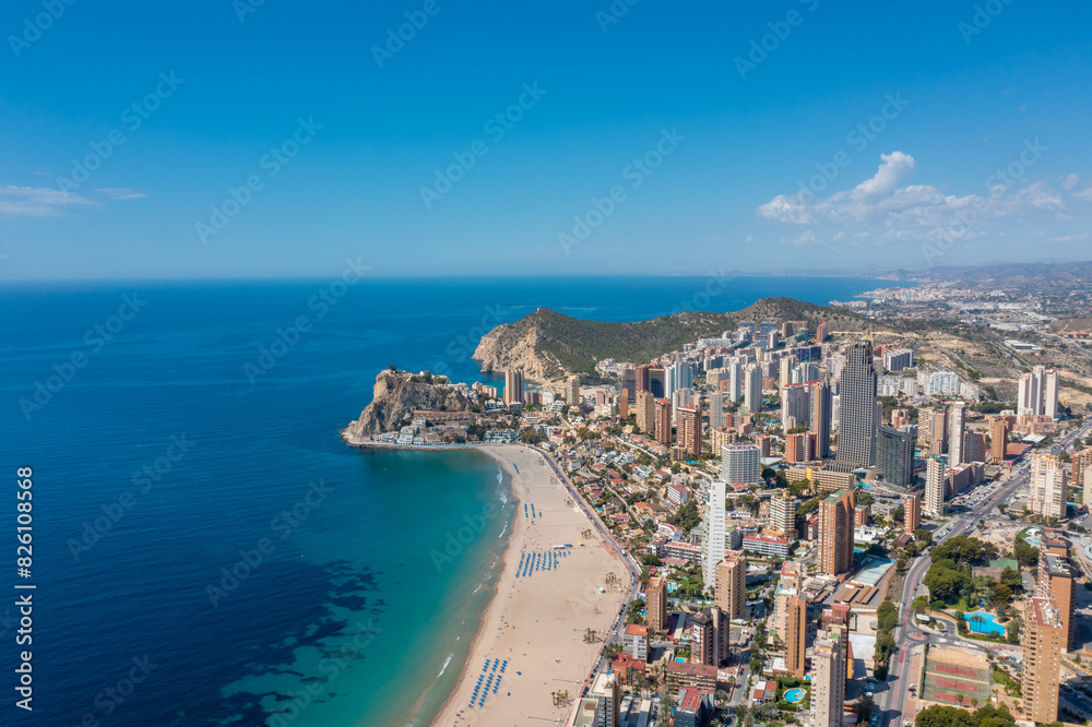 Aerial drone photo of the beautiful town of Benidorm in Spain showing the south beach Promenade golden sandy beach and apartments on a sunny summers day with a blue sky and a few clouds Aerial drone photo of the beautiful town of Benidorm in Spain showing the south beach Promenade golden sandy beach and apartments on a sunny summers day with a blue sky and a few clouds