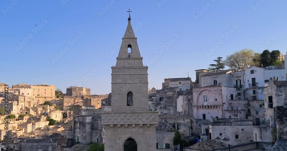 Matera holiday, summer, panorama of historic Matera stone with bell tower under blue sky, European Capital of Culture 2019, concept of cultural holidays vacation and tourism in Italy and culture Matera holiday, summer, panorama of historic Matera stone with bell tower under blue sky, European Capital of Culture 2019, concept of cultural holidays vacation and tourism in Italy and culture