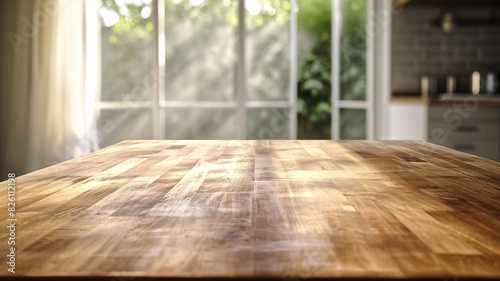 Empty wooden table in a sunlit kitchen with blurred background. Depth of field photography with copy space. Design for banner  poster  or header.