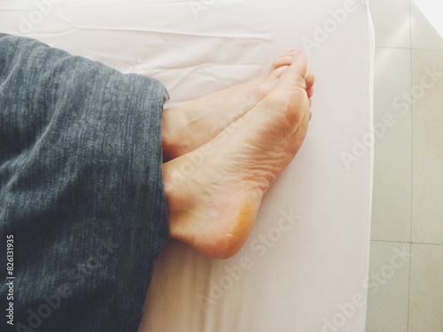 feet of a person on a bed