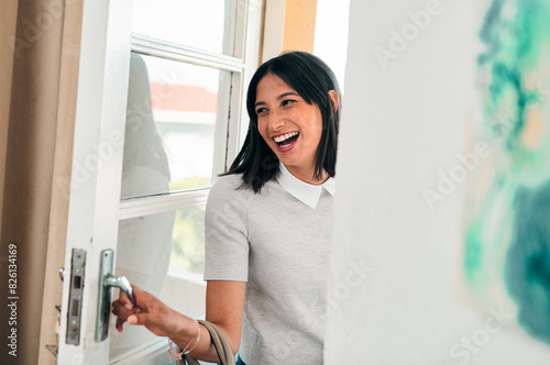 Girl, happy and front door for leaving home to work or creative job as fashion designer, excitement and journey. Woman, setting off and embarking to university or school, walk out and apartment