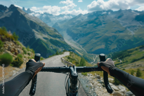 A close-up of a cyclist's hands gripping the handlebars tightly as they climb the steep slopes of Alpe d'Huez