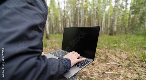 person working on laptop outdoors