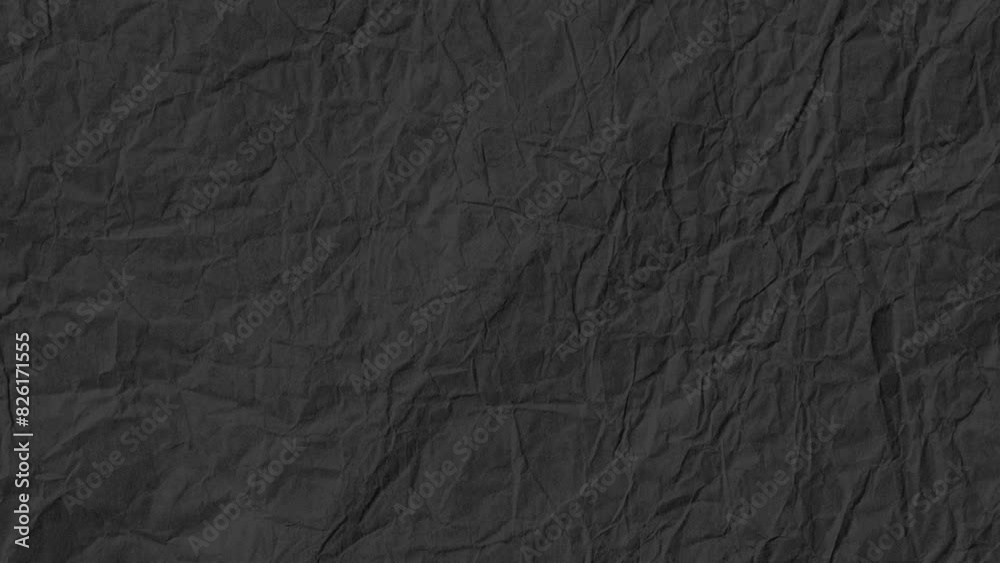 Stop motion animated paper texture background. Crumpled Black Paper Looping Animation in 4k. Quick changing.