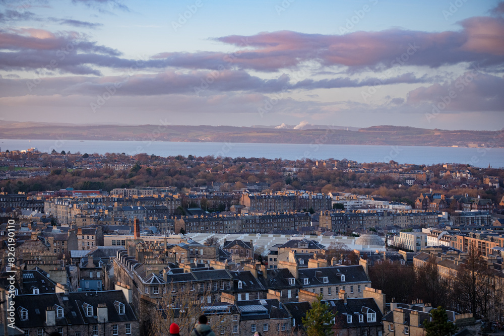 Fototapeta premium Edinburgh Scotland: 13th Feb 2024: Edinburgh city skyline and Firth of Forth view from Carlton Hill lookout point at dusk