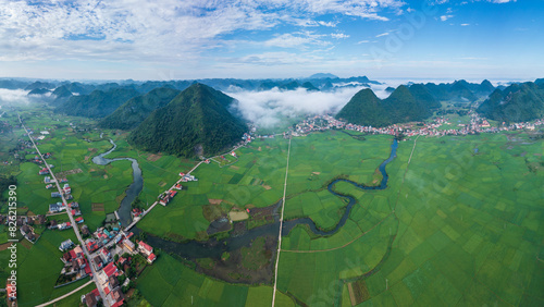 Aerial view of Bac Son valley with lush rice field and winding river.  photo