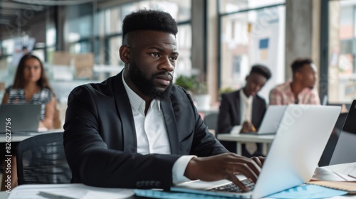 Professional African American Businessman Communicating with Colleagues Using Laptop in Office. 4K HD Wallpaper, Background, AI-Generated.