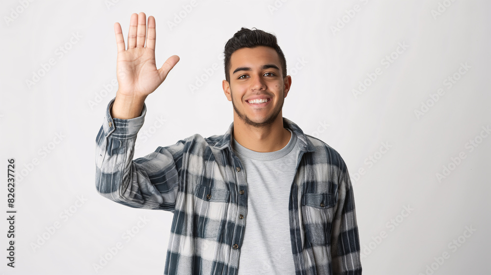 Smiling Hispanic Man in Plaid Shirt Waving Hand on White Background Smiling Hispanic Man in Plaid Shirt Waving Hand on White Background