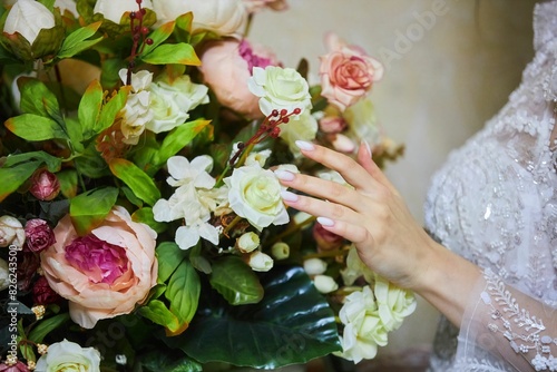 Decor for a wedding or engagement party. The bride's hands on the flowers