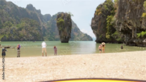 family walking on the beach, Kao Tapu, a cafe on the famous of Kao ping Kan, also known as James bond Island in Phang nga Bay, Thailand with blurred background photo