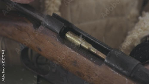 Loading bullet in vintage riffle in battle World War One photo