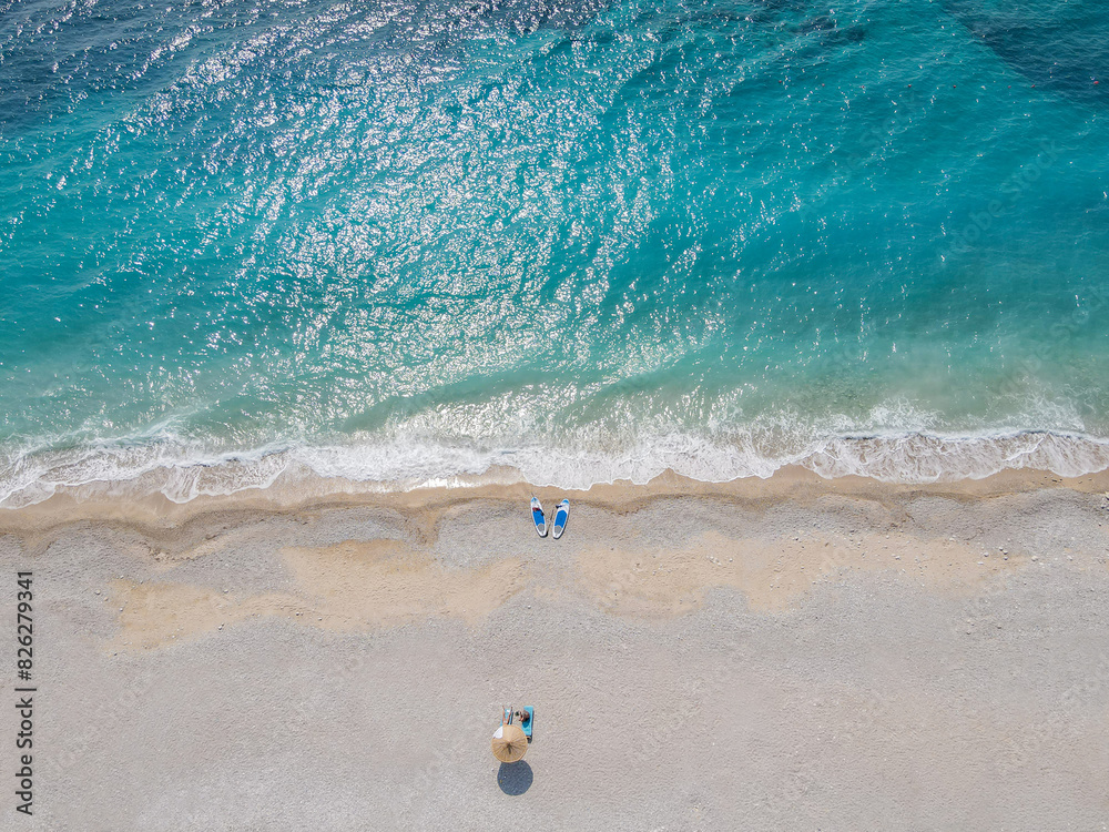 Obraz premium Aerial view of a sandy beach with turquoise water