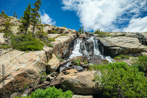 Crystal clear waterfall cascading down rocky terrain