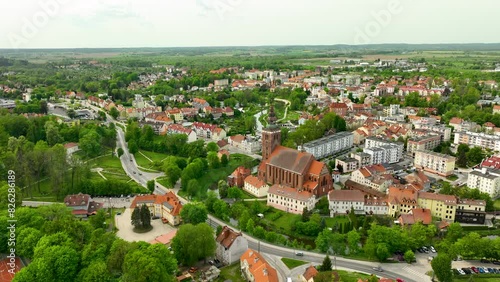 Traffic on Main Street of Lidzbark Warminski Town with famous historic cathedral. Housing. Area neighborhood in Poland. Aerial wide shot. photo