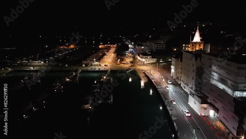 Flight at night along illuminated St Peter Port seafront in Guernsey over Victoria Marina,Albert Marina and looking down South Esplanade with Prince Albert statue photo