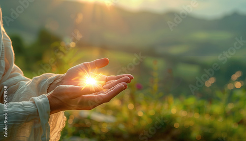 a detailed image of Jesus Christ's hands cupped together, holding a bright, ethereal light, with a softly blurred background of a peaceful landscape, signifying prayer and spiritua photo