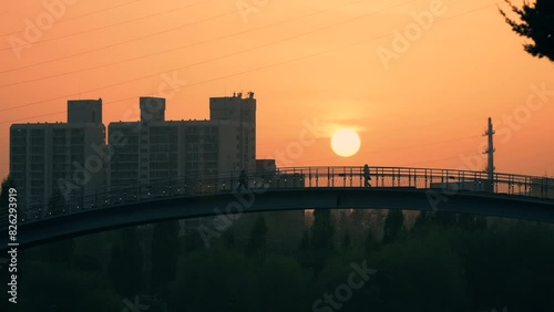 People In Silhouette Walking At Seonyudo Bridge At Sunset On Hangang River, Yeongdeungpo, South Korea. wide shot photo