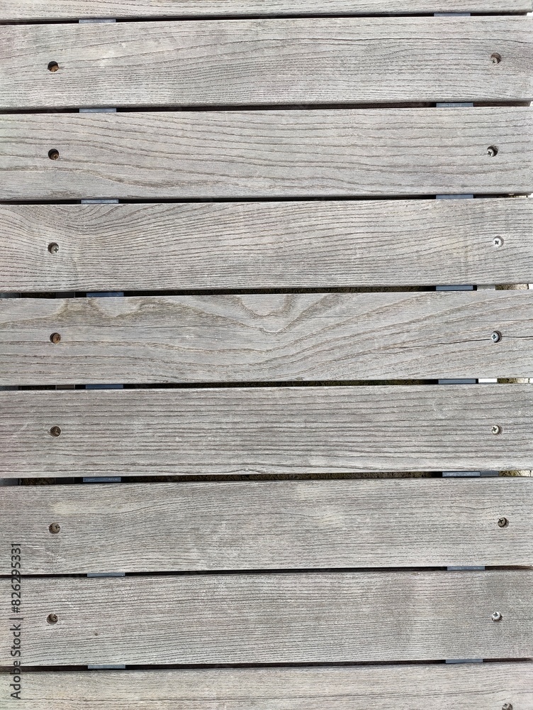 Close-Up of Weathered Wooden Surface with Natural Grain and Visible Fasteners Indicating Outdoor Use Close-Up of Weathered Wooden Surface with Natural Grain and Visible Fasteners Indicating Outdoor Use
