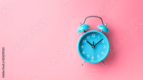 Simple blue alarm clock on a pink background. Modern and minimalist style. Great for time-management concepts and waking up themes. AI photo