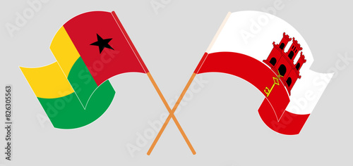 Crossed and waving flags of Guinea-Bissau and Gibraltar