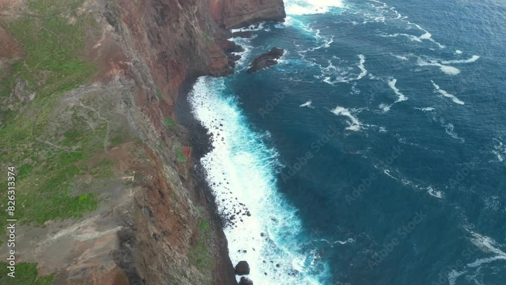 Aerial view of the Atlantic Ocean waves on the shores of Ponta Do Rosto viewpoint, Madeira, Portugal