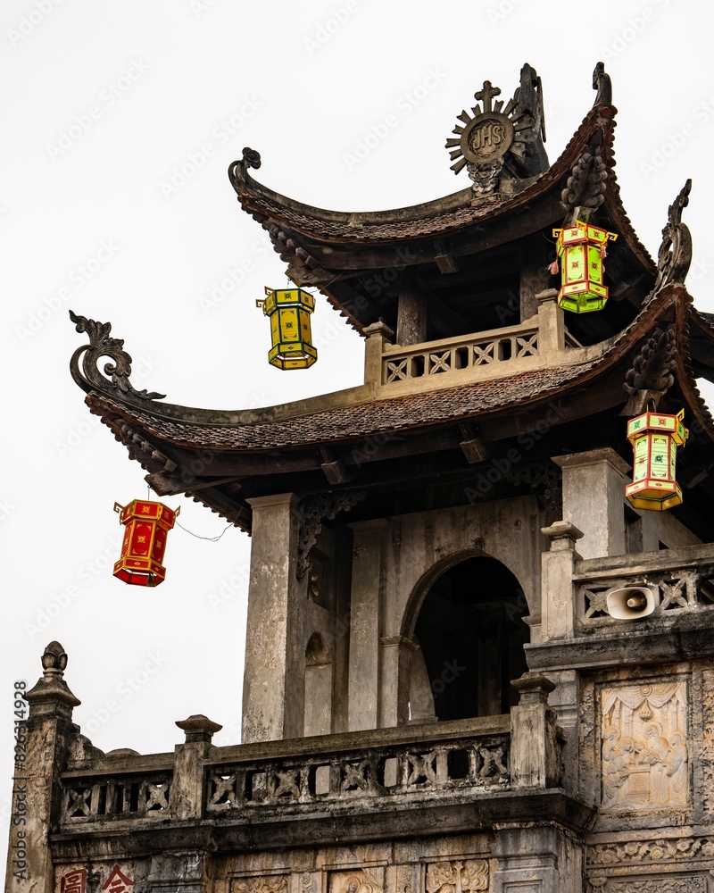 Fototapeta premium Exterior of Phat Diem Cathedral in Northern Vietnam with spires, cross, doorways, and lanterns