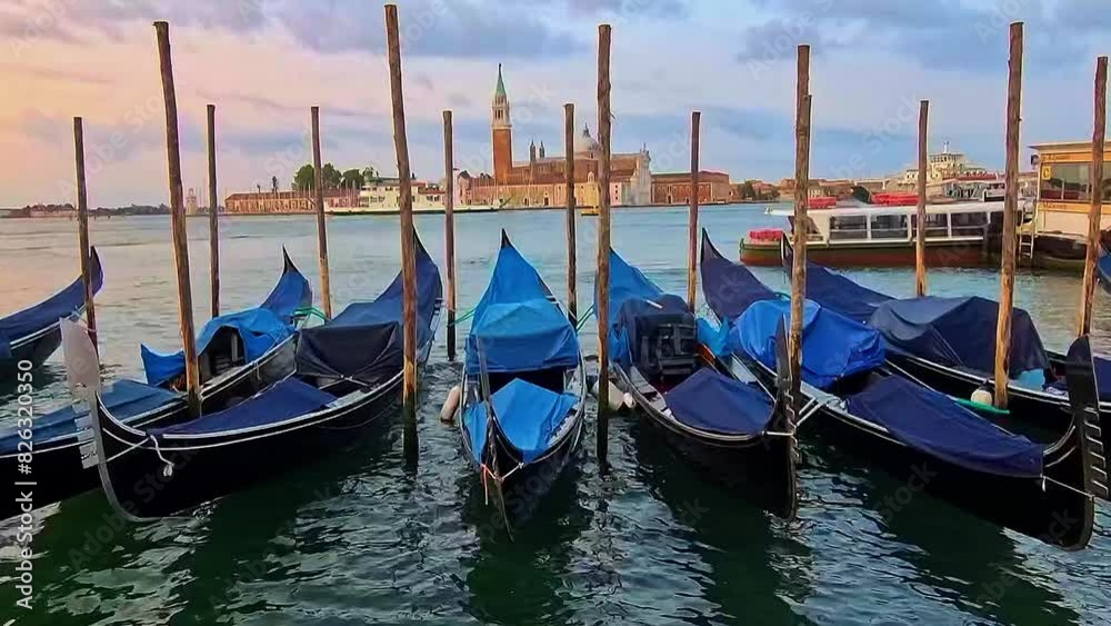 Gondolas dancing on the waves with San Giorgio island at the background. Venice, Italy Gondolas dancing on the waves with San Giorgio island at the background. Venice, Italy