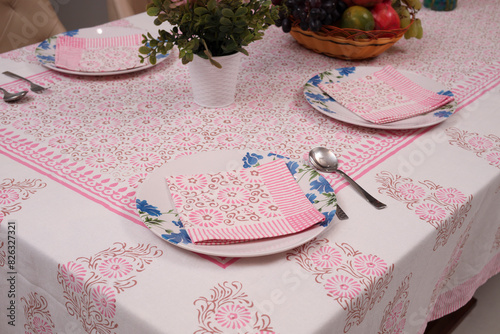 white and pink Traditional floral design table cloths on table with decoratation of plates photo