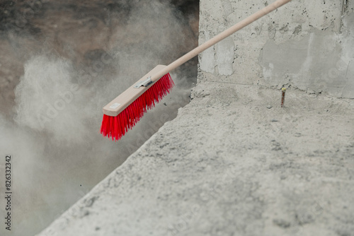 a broom has been washed out onto a cement wall by a steamifier