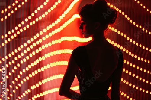 Woman's silhouette stands out with a vibrant backdrop of glowing red neon lights