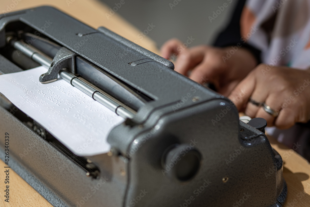 Blind person with a braille machine, Disability concept Blind person with a braille machine, Disability concept
